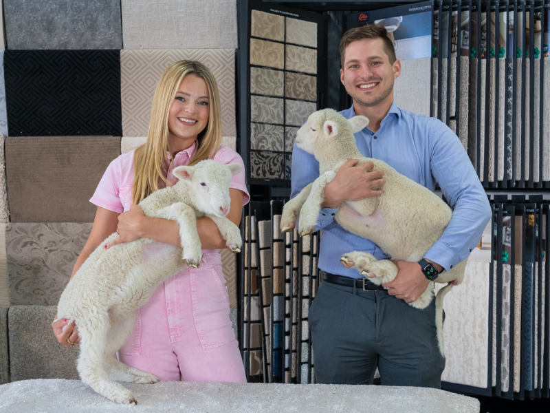 Lauren and Jack Coles holding sheep